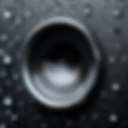 A close-up view of an iPhone speaker with moisture droplets